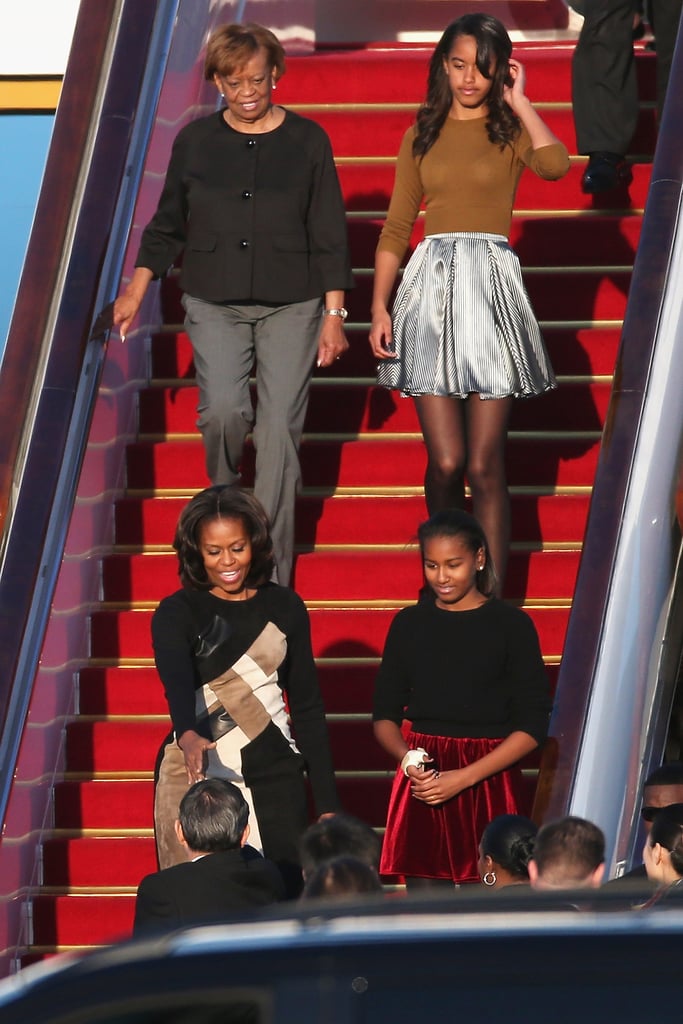 Malia and Sasha Obama coordinated in skirts and tights while traveling.