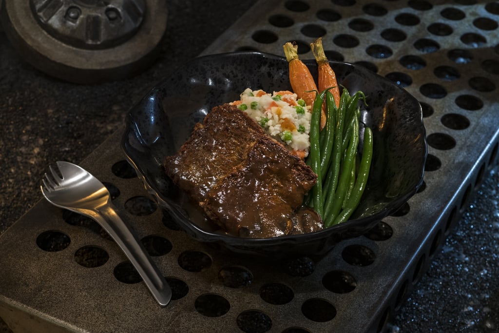 This Ithorian Garden Loaf, or a plant-based "meatloaf" dish served with roasted vegetable mash, seasonal vegetables, and mushroom sauce, can be found at Docking Bay 7 Food and Cargo.