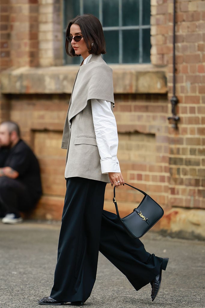 This attendee layered a vest over a white long-sleeved button-down.

Read more of our Fashion Week content.