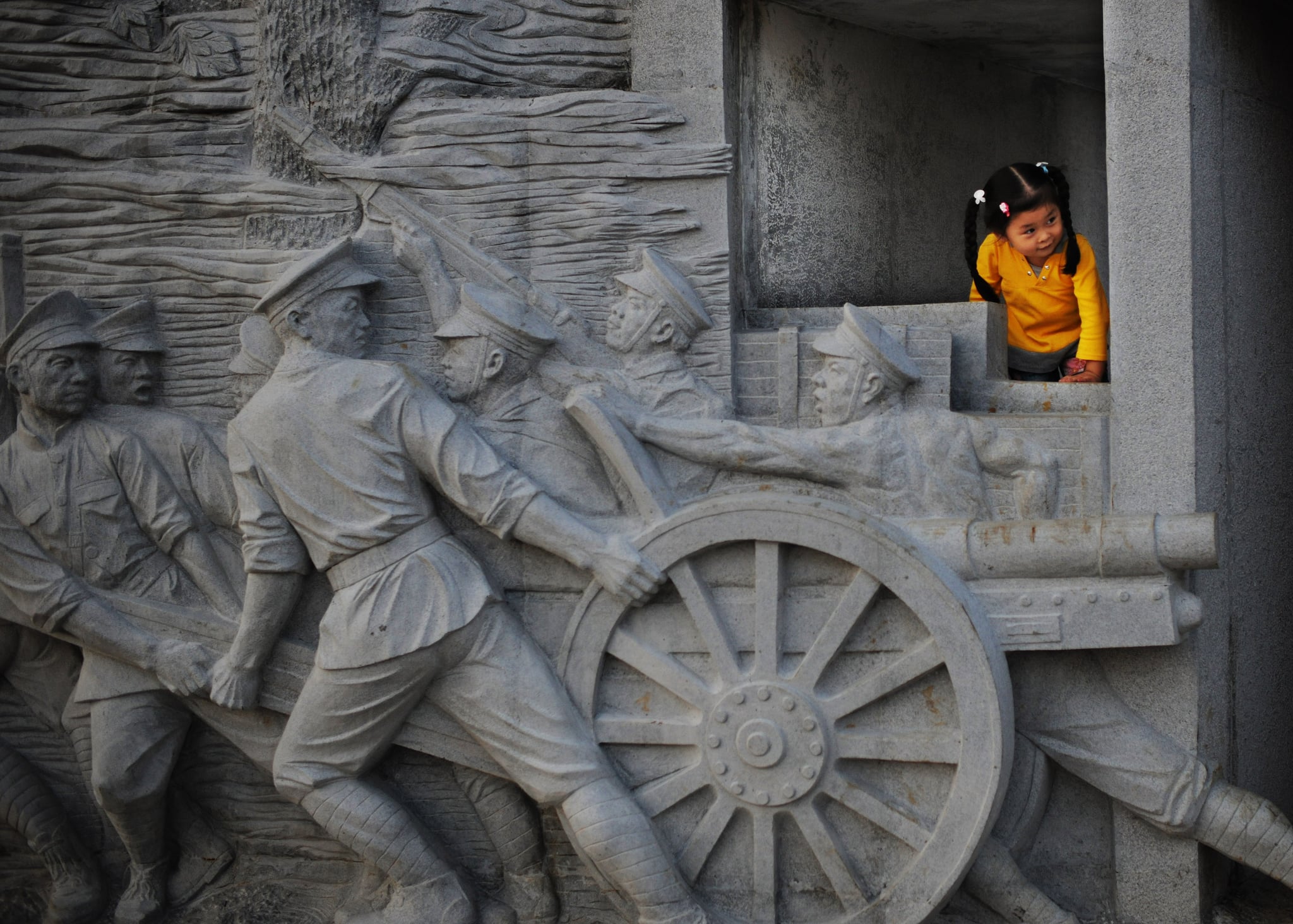 WUHAN, CHINA - OCTOBER 8: (CHINA OUT) A girl plays near the Gate of Wuchang Uprising renovated recently as part to mark the upcoming 100th anniversary of Wuchang Uprising October 8, 2011 in Wuhan of Hubei Province, China. This year marks the 100th anniversary of Wuchang Uprising of October 10, 1911 that started the 1911 Xinhai Revolution, led by Chinese leader Sun Yat-sen, which dethroned the feudal domination of Qing Dynasty. (Photo by China Photos/Getty Images)