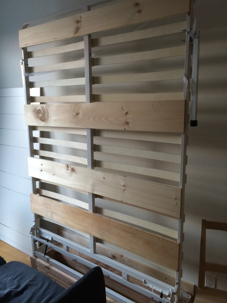 To make the bottom of the bed less of an eyesore, add wooden slats and attach panels.