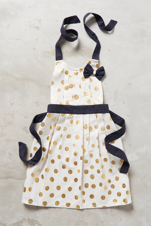 Anthropologie Gold Polka Dotted Kid's Apron ($18) or this gender-neutral Denim and Stars Apron Set ($45)