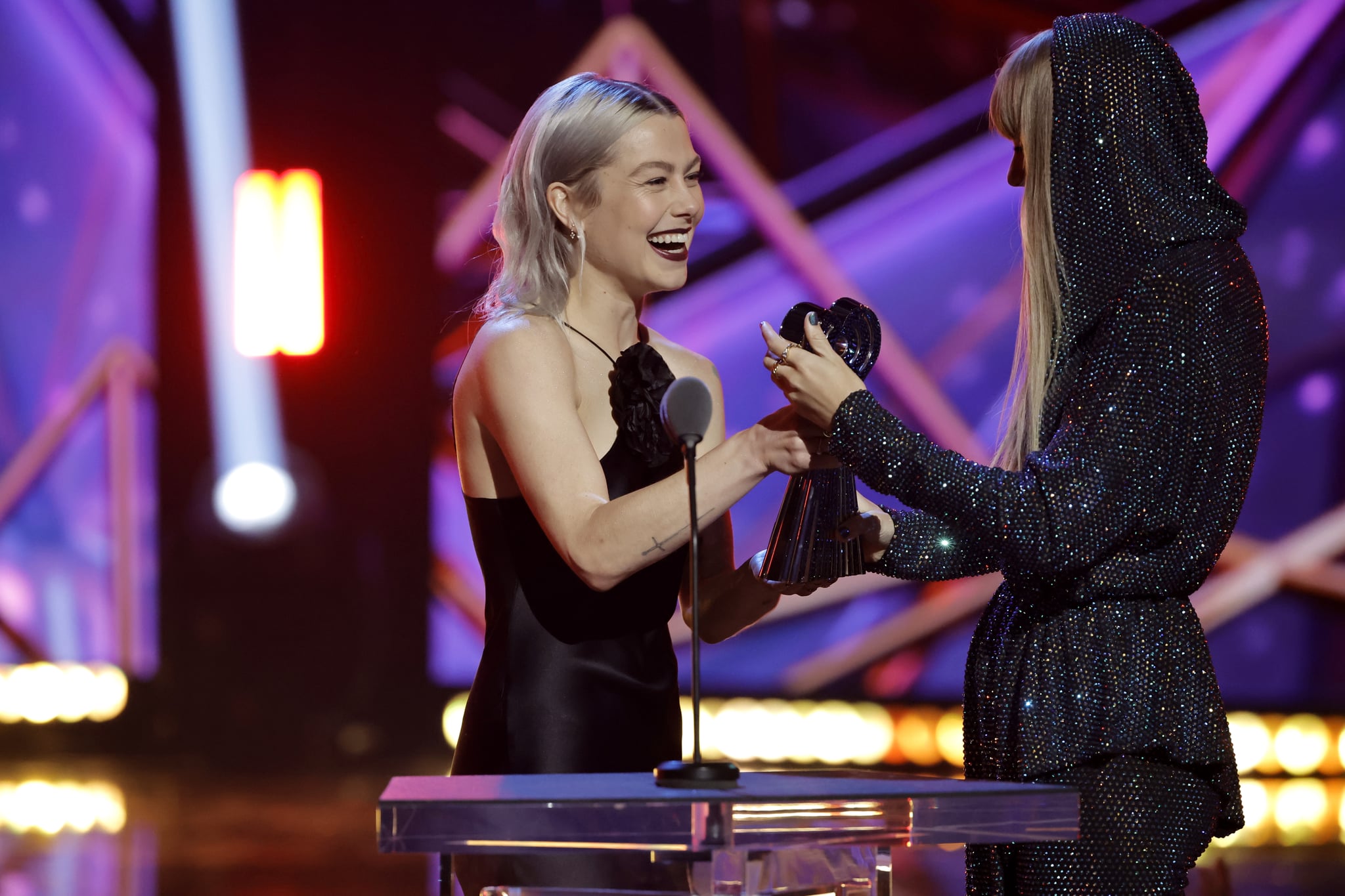 LOS ANGELES, CALIFORNIA - MARCH 27: (FOR EDITORIAL USE ONLY) (L-R) Phoebe Bridgers presents the iHeartRadio Innovator Award to honoree Taylor Swift onstage during the 2023 iHeartRadio Music Awards at Dolby Theatre in Los Angeles, California on March 27, 2023. Broadcasted live on FOX. (Photo by Kevin Winter/Getty Images for iHeartRadio)