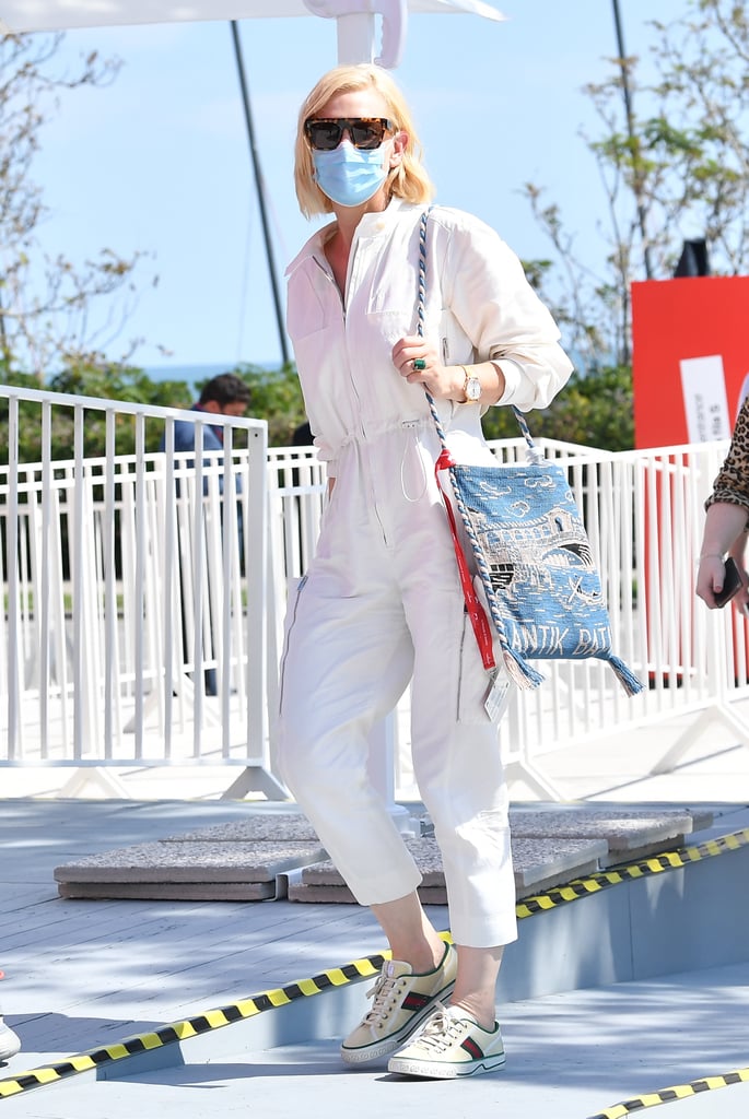 Cate Blanchett stepped out in a white jumpsuit, Stella McCartney sunglasses, and Gucci sneakers for day three of the festival.