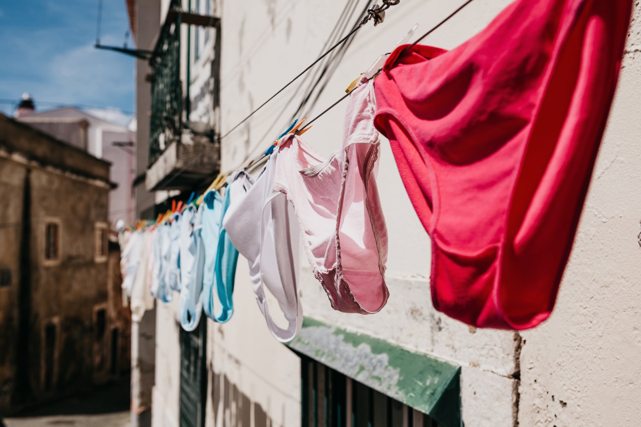 Authentic photography. Close-up panties dry on the street in Lisbon in Portugal. The national peculiarity of the Portuguese is to dry clothes on the outside of the house. Feature of culture.
