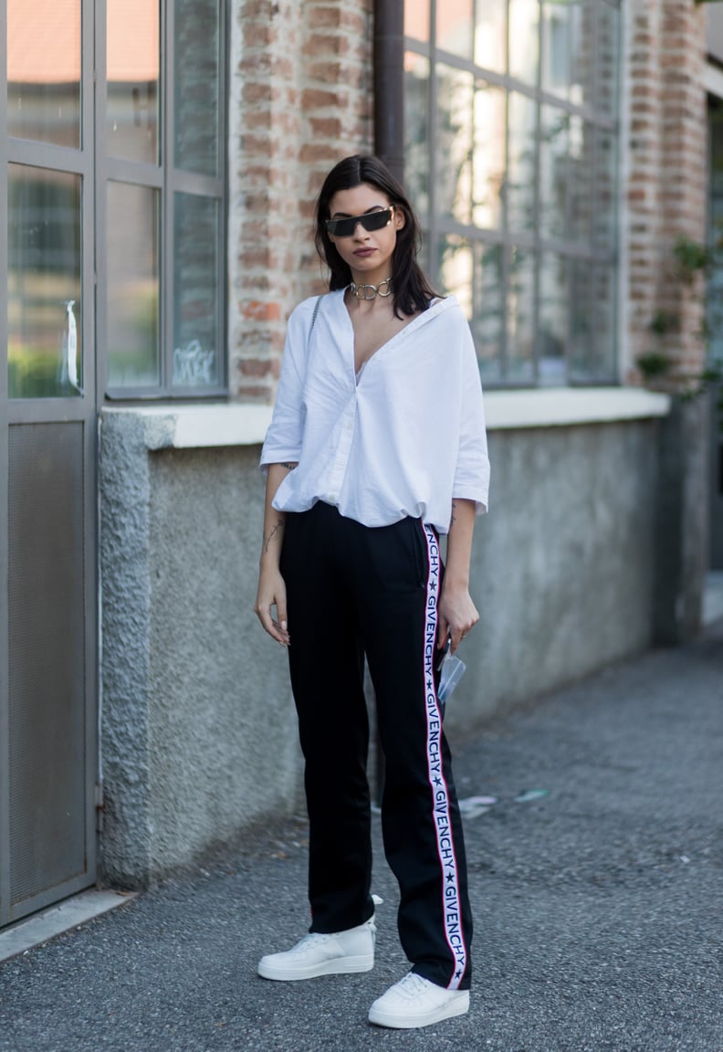 Wear Your Sweatpants With a Chic White Blouse and Futuristic Sunglasses