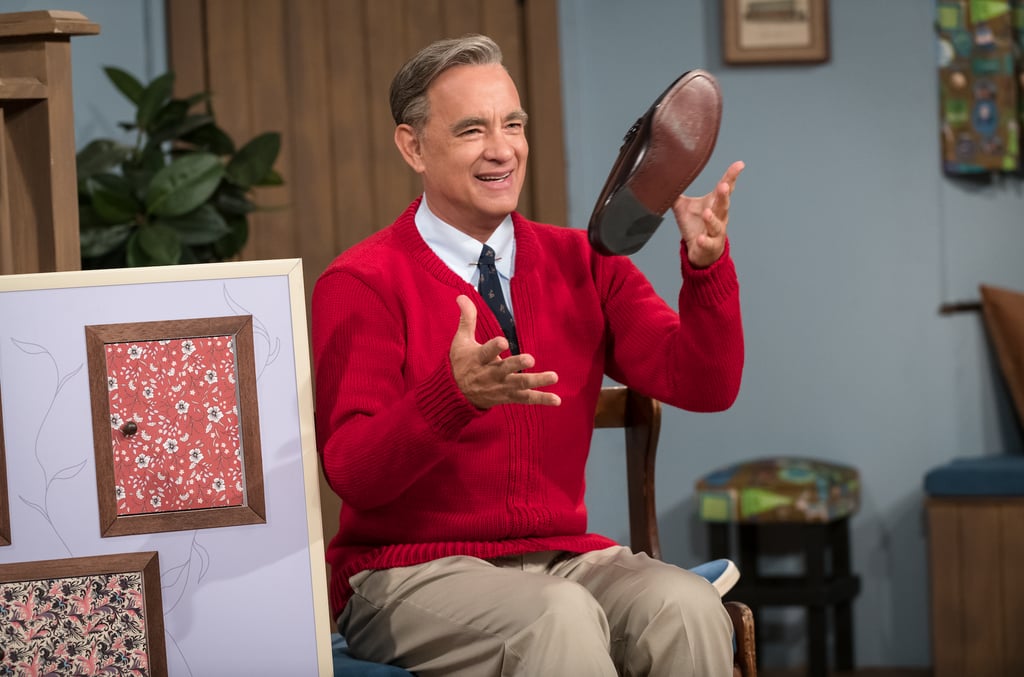 After even the darkest storms, there's a rainbow, and today it came in the form of a red sweater. On Wednesday, Sony released two new photos of Tom Hanks as Mister Rogers in the upcoming You Are My Friend movie, and we. are. emotional. Not only is Hanks the perfect actor to portray Fred Rogers, but let's discuss how incredible he looks. From the parted hair all the way down to the trademark shoes, we're already nodding our heads in awe over whatever words of wisdom are about to come out of his mouth. 
The biopic is inspired by "the real-life friendship between Fred Rogers and award-winning journalist Tom Junod," and will hit theaters on Oct. 18, 2019. While it's been some time since the final episode of Mister Rogers' Neighborhood aired on Aug. 31, 2001, it's safe to say we could all use a bit of his nurturing energy and positive spirit in our lives. Read on to see how fans are freaking out over the first photos of Hanks as Mister Rogers, and believe that he can turn any crappy climate into a beautiful day in the neighborhood.

    Related:

            
            
                                    
                            

            10 Facts About Mister Rogers That Will Put a Smile on Your Face and a Song in Your Heart