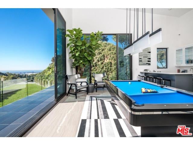 This room with a billiards table and a bar looks ideal for entertaining.