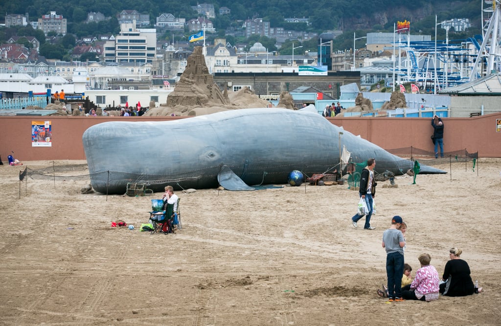 Beachgoers snapped photos of an inflatable whale that was erected by the Bible Society in the UK.