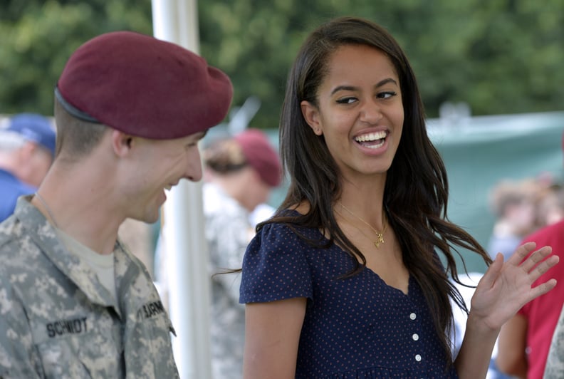 Malia Obama, daughter of US President, (R) smiles as she serves food during a lunch at the United States and Nato military base in Vicenza  on June 19, 2015 .   AFP PHOTO / ANDREAS SOLARO        (Photo credit should read ANDREAS SOLARO/AFP via Getty Image