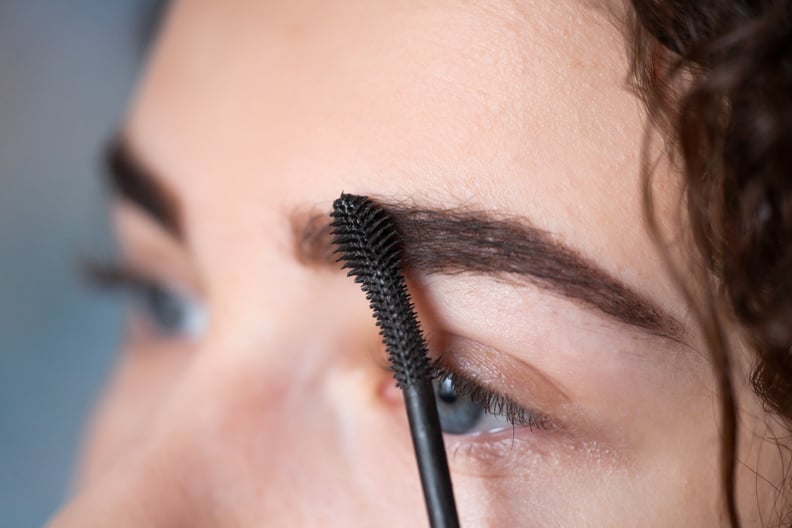 Young woman undergoing eyebrow correction procedure. Beauty and makeup concep