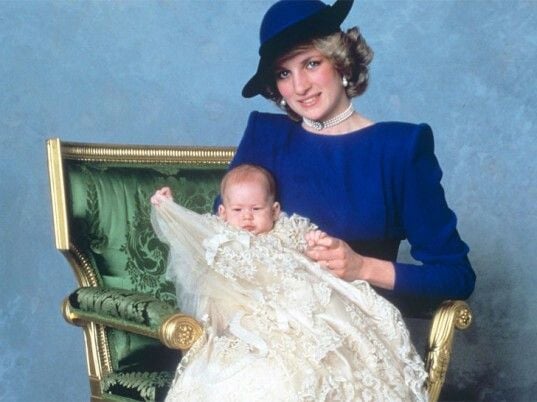 This portrait of Prince Harry and Princess Diana, from his christening, featured the blue studio background many of us recall from our school pictures. 
Source: