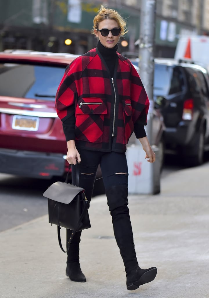 A bright plaid coat added color to Karlie Kloss's dark ensemble.
