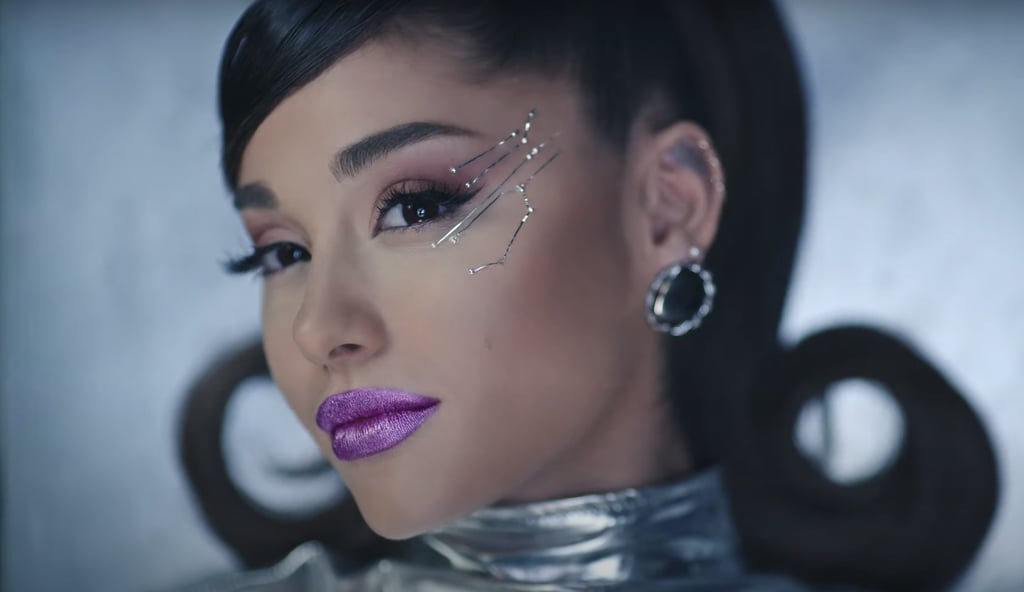 BAM! Ariana's Fembot Hit Us With a Metallic Purple Lip and Electrifying Eye Jewellery