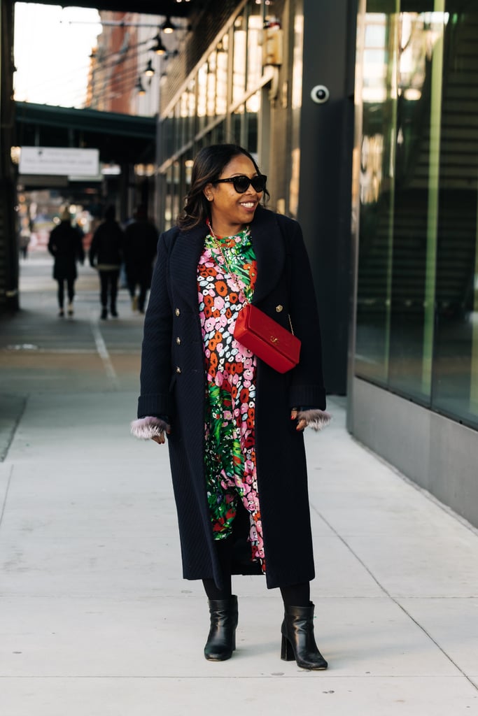 Sade Strehlke made a case for joyful dressing in a Broger flower print dress from Hampden, a fiery red Chanel quilted bag from Vivrelle, a long black Chanel double-breasted coat, and hair by Amor Sonia at Suite Reyad.