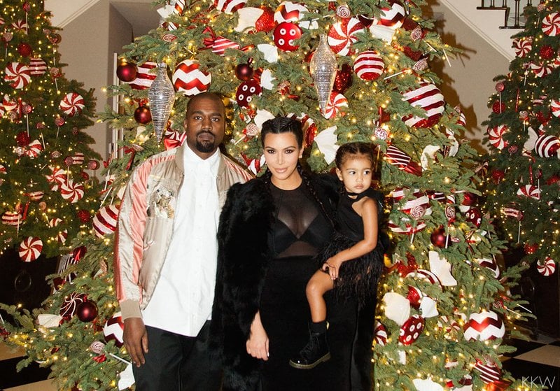 It's no secret that the Kardashian family Christmas card is always a big deal, but so are their parties. This year, the Kardashian-Jenner clan held their annual Christmas Eve bash on Thursday, and as usual, it boasted a star-studded guest list. Kris Jenner and her daughters Kendall Jenner, Khloé Kardashian, and Kim Kardashian — who was joined by her daughter, North West, and husband Kanye West — were all in attendance, along with Kylie Jenner, who brought her rapper boyfriend, Tyga. Kourtney Kardashian also stepped out for the soiree with her daughter, Penelope Disick, in tow. Family friends Jonathan Cheban, Malika Haqq, Brittny Gastineau, and Drake made fun appearances, as well as Jennifer Lopez, Toni Braxton, Tyler the Creator, Carla DiBello, and Sarah Howard. But the real belle of the ball was Caitlyn Jenner, who turned heads in a sexy black dress.

Of course, it didn't take very long for the famous brood to take to Instagram to share snaps from the holiday extravaganza. Kylie uploaded photos to both her website and her Instagram account, jokingly captioning the photo of herself with Drake and her mom, "Me, my mom, and a photobomb," as well as Kim, who shared a bevy of photos on her website. Read on to see more photos from the over-the-top party, and then check out the brood's Christmas cards through the years.