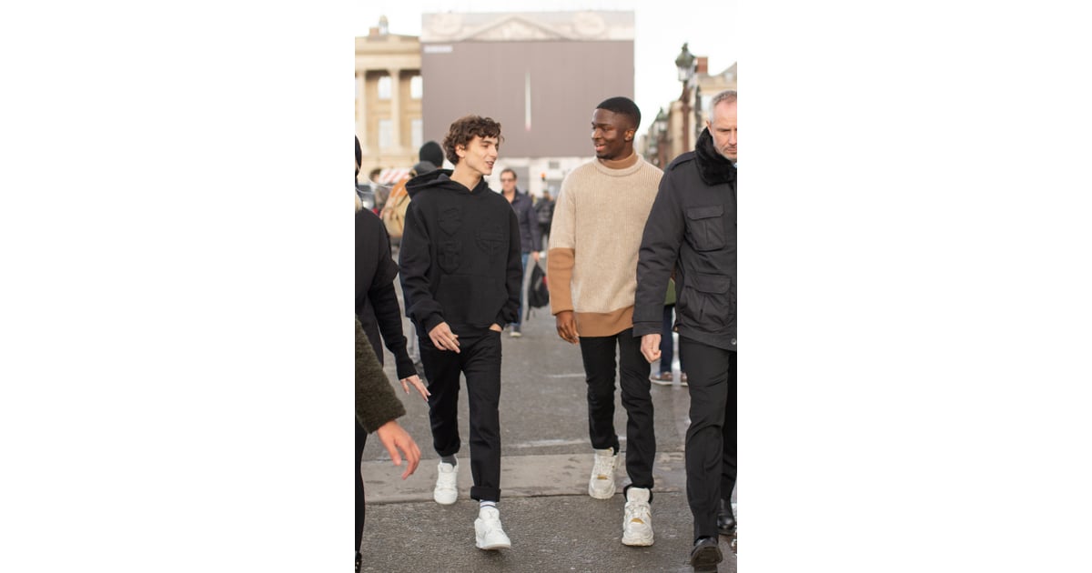 Chatting with a friend wearing a black Louis Vuitton hoodie, pants,, 11  Times Timothée Chalamet's Street Style Was Pretty Damn Amazing