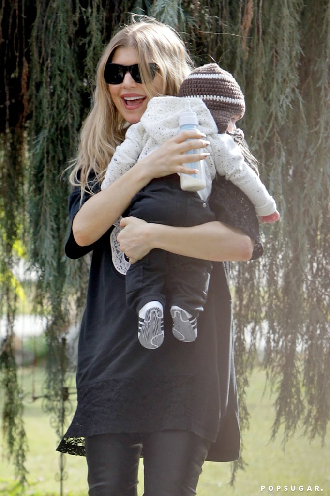 Fergie was all smiles while holding her son, Axl, in LA on Super Bowl Sunday.