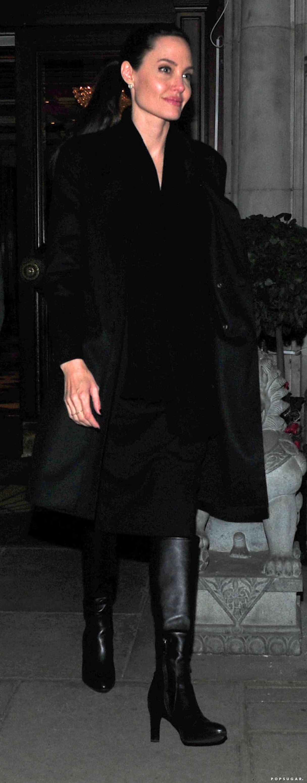 Angelina Jolie in black blazer with black tall boots, black