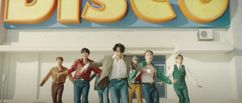 Here's Jungkook wearing a relaxed denim jacket by Louis Vuitton while, BRB, Admiring the Amazing Outfits in BTS's Dynamite Music Video For Hours  on End
