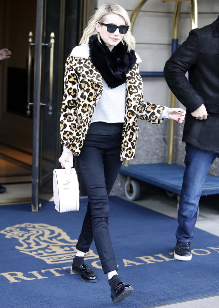 Emma recently paired her favorite leopard coat with a furry scarf, white t-shirt, and loafers.