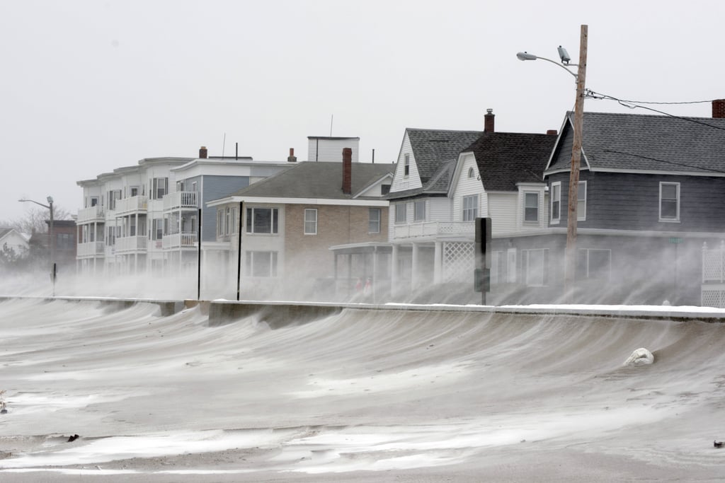 Areas north of Boston saw nearly two feet of snow during the first night of the storm, and strong winds blew snow across the beach in Winthrop, MA.