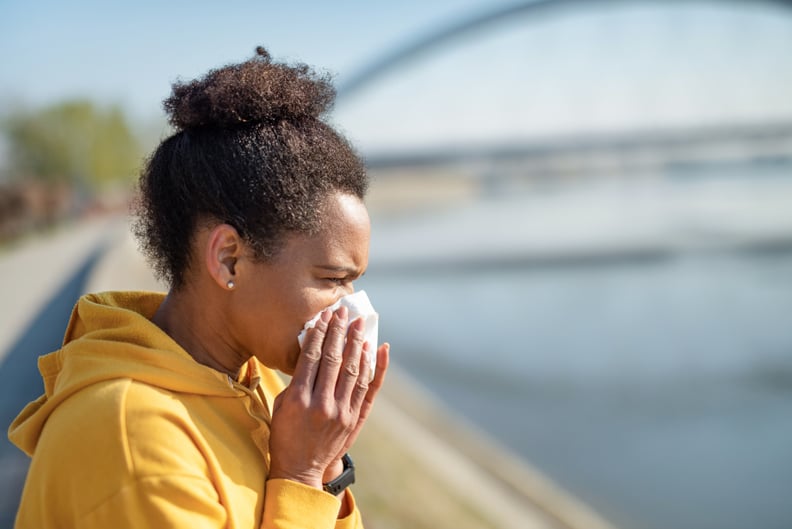 African American mid adult woman sneezing.