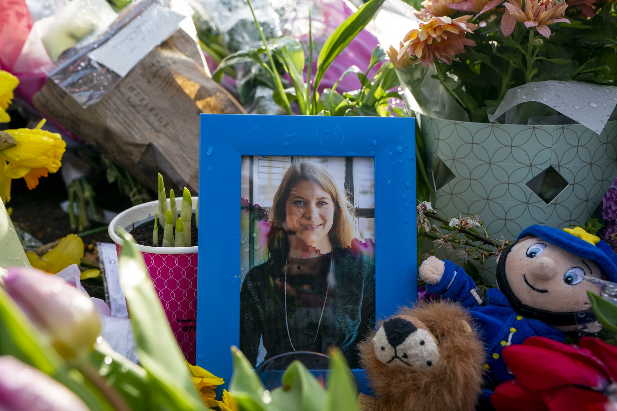 LONDON, ENGLAND - MARCH 15: A picture of Sarah Everard sits amongst flowers left at the bandstand, Clapham Common where floral tributes have been building up over the last few days on March 15, 2021 in London, England. Hundreds of people turned out at Clapham Common on Saturday night to pay tribute to Sarah Everard, a 33-year-old London resident whose kidnapping and death - allegedly at the hands of an off-duty Metropolitan Police officer - prompted a wave of concern over women's safety. The same police force is being criticised for its response to the vigil, where they forcibly arrested several participants for violations of pandemic-era rules on public assembly. (Photo by Ming Yeung/Getty Images)