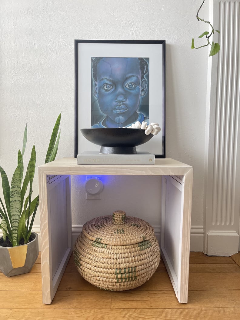 pura smart fragrance diffuser with night light turned on in living room