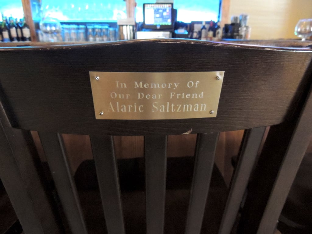When Alaric died in season three, the owners of the restaurant commemorated his memory by putting a special plaque on the back of his chair. Of course, that's null and void now that he's been revived from the dead (along with practically everyone else on the show).
