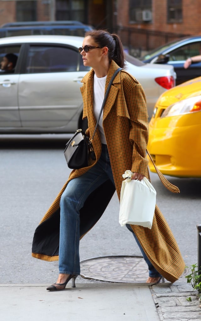 Katie makes the errand run look infinitely cooler with a trench coat thrown over a white tee and jeans.