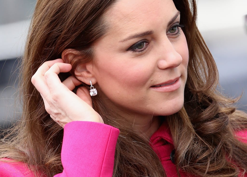 She styled her look with dainty diamond drop earrings.