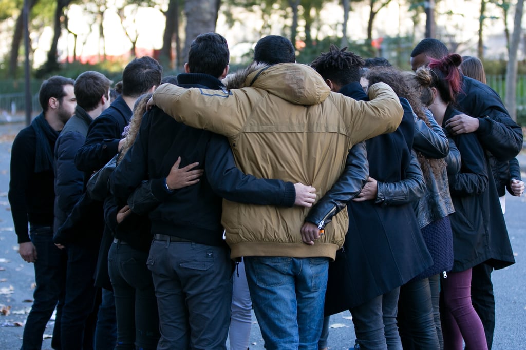 People hugged in memory of a victim near the Bataclan Theater in Paris.