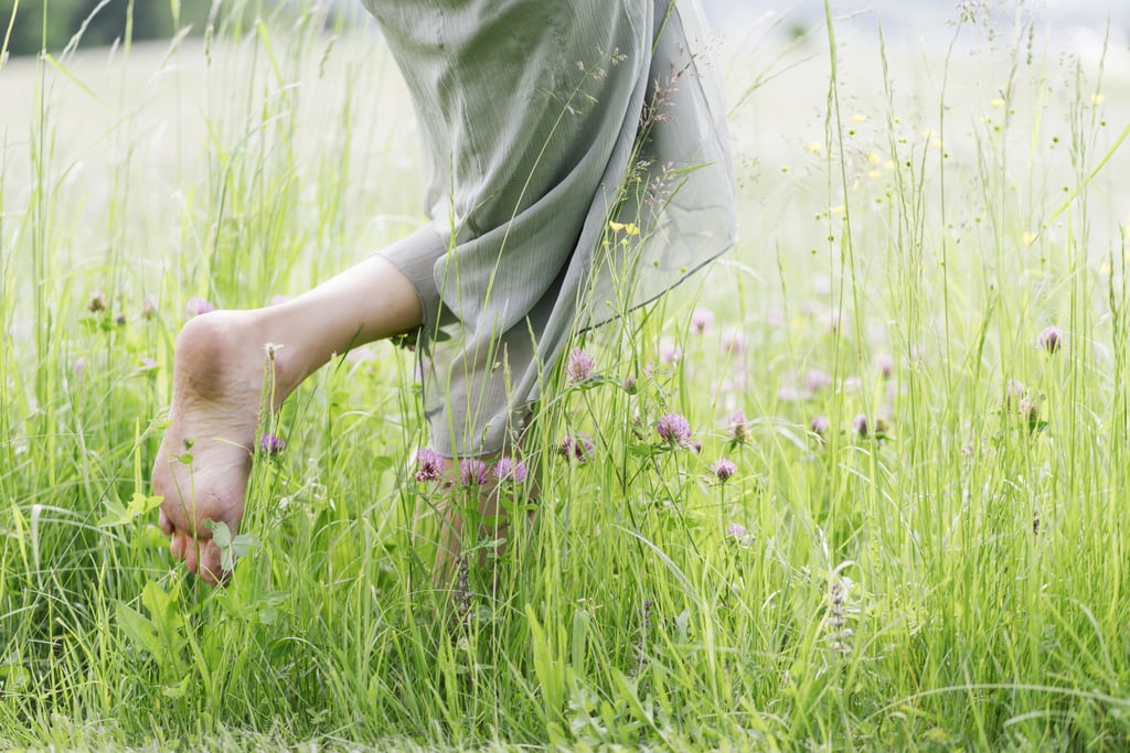 Walking barefoot in the grass.