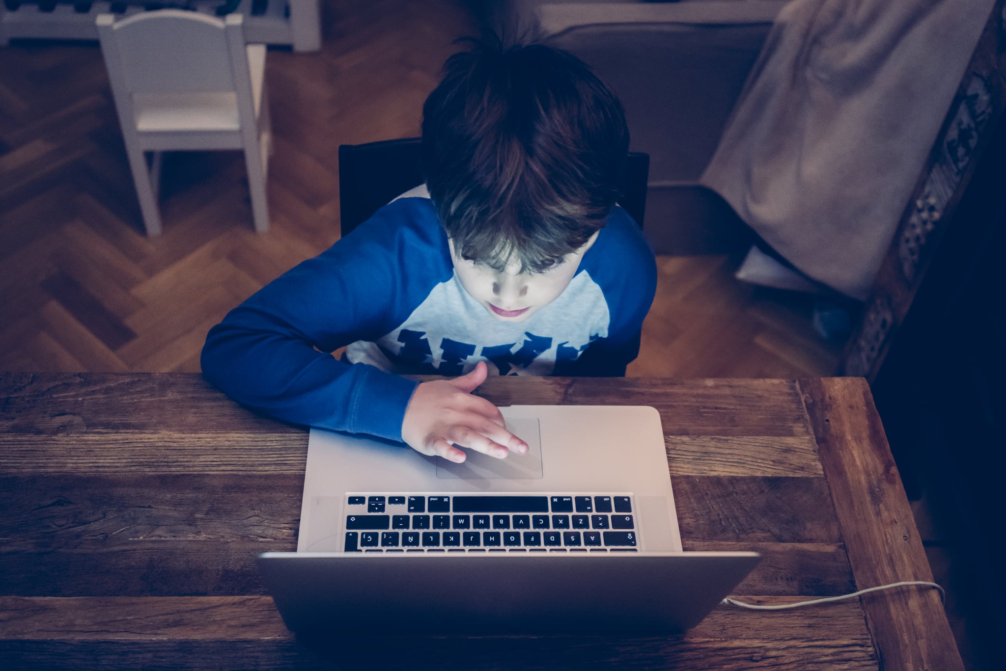 Four years old child studying and learning with a digital tablet.