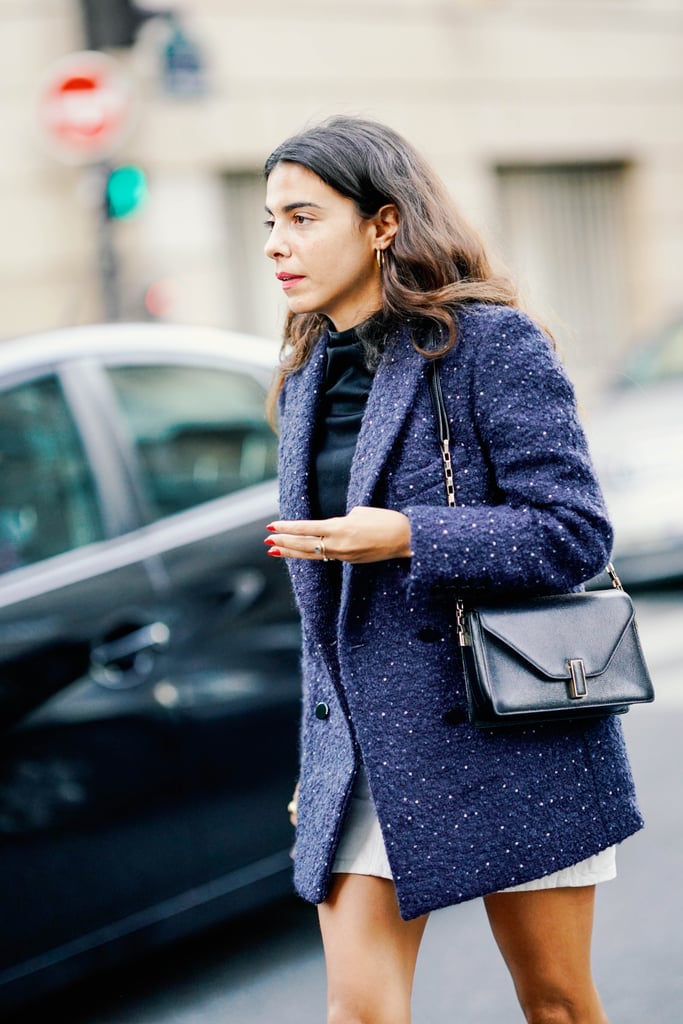 A tweed blazer and sleek shoulder bag give a miniskirt a ladylike feel.