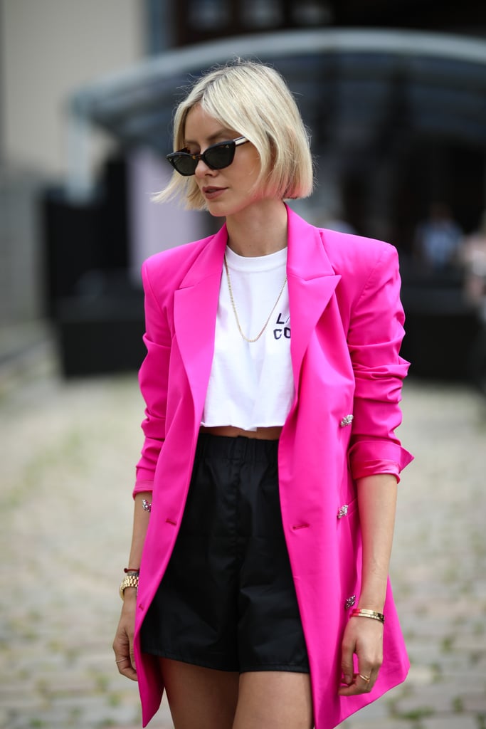Go bright with a pair of high-waisted black shorts, cropped T-shirt, and bold blazer to amp up your look.