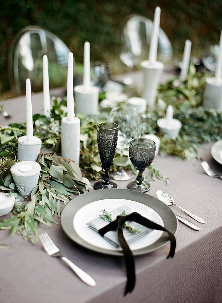 For an elegant centerpiece, keep it simple with white candlesticks and scattered greenery. 
Photo by Clayton Austin via Style Me Pretty