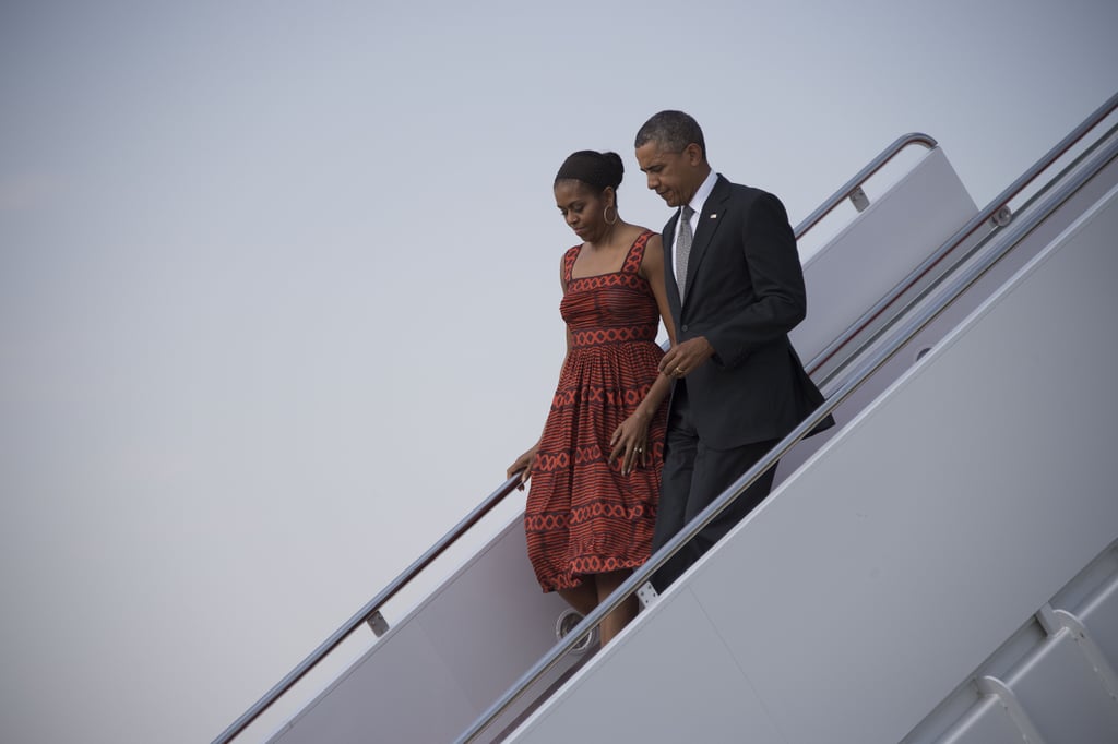 Michelle wearing a burnt orange printed dress, wide headband, and hoop earrings in Maryland.