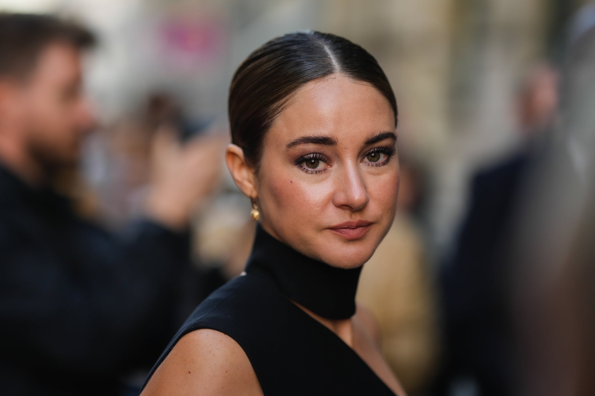 PARIS, FRANCE - OCTOBER 01: Shailene Woodley wears a black high neck / asymmetric shoulder / sleeveless tube long dress, a black shiny quilted leather handbag from Dior , outside Monot, during Paris Fashion Week - Womenswear Spring/Summer 2023,  on October 01, 2022 in Paris, France. (Photo by Edward Berthelot/Getty Images)