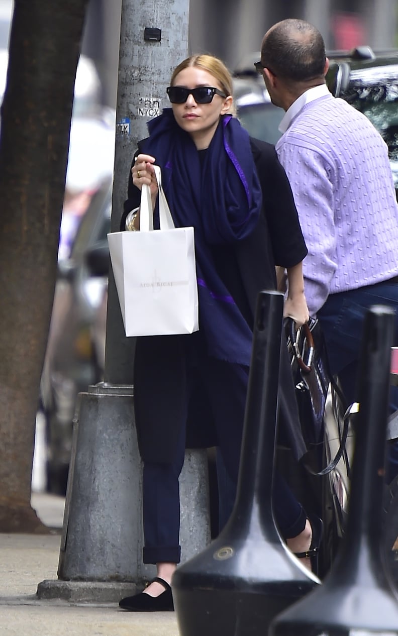 She Paired the Shoe With Navy Pants, a Dark Coat, and a Scarf