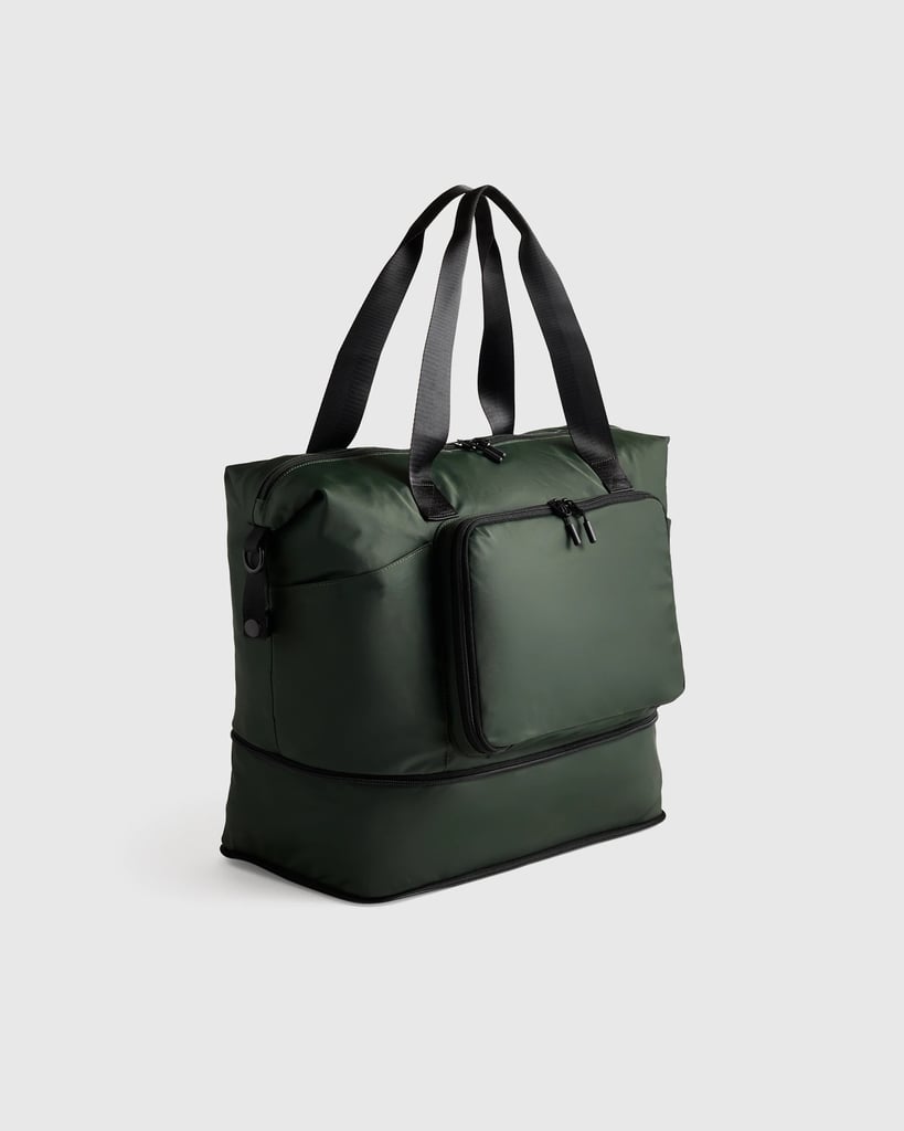 Quince Packable Expandable Travel Tote ($45)
This water-repellent bag has a discreet, expandable base for shoe storage, plus a detachable pouch at the front for keeping smaller items like headphones and a fitness tracker. When you're stowing it away after use, you can even zip it into a more compact size, making it appear as small as a laptop sleeve! Use it as a carry-on bag for travel, then your gym bag when you arrive at your destination.
Pros: The design is smart and functional, and the material is durable
Cons: It takes some practice to learn how to unzip it and zip it back up into its iterations
Material: Water-repellent nylon twill
Dimensions: 11"H (15.5" H when expanded) x 23"W x 8"D
Colorways: Three
Who It's Best For: Travelers who are also workout enthusiasts
Extras: The expandable bottom gives you 4.5 more inches of space, and it comes with a removable and adjustable strap with a padded shoulder guard
What Reviewers Say: "The design of this duffel is incredible. Zips up nice and small and then expands to two perfect sizes, a medium size duffel and then another section expands to create more space. Genius."
