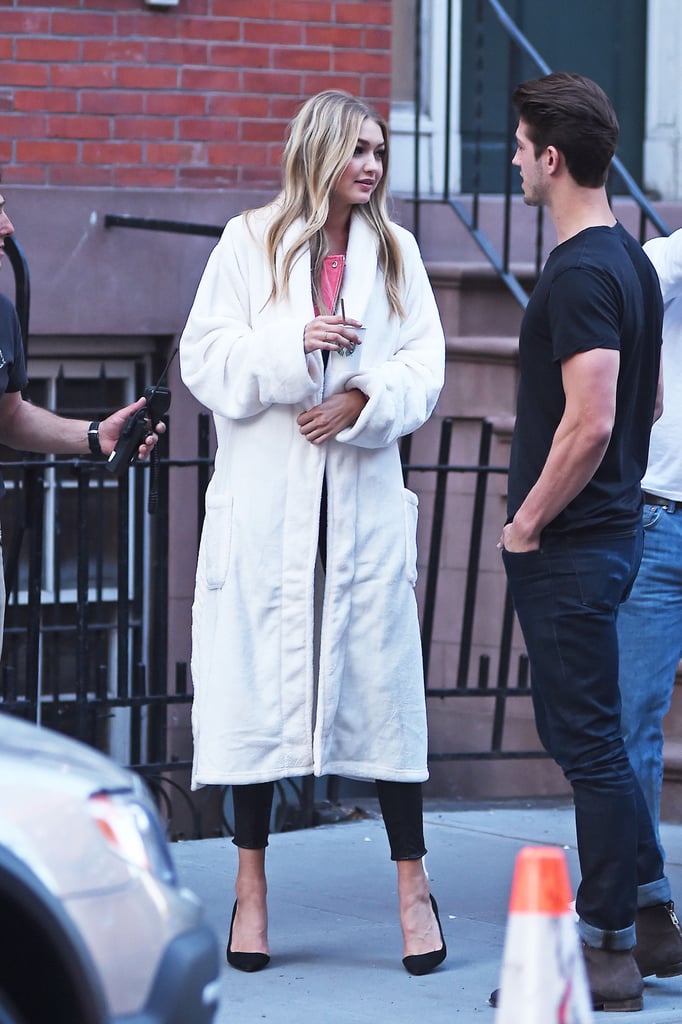 Gigi was originally spotted rocking a robe on set, covering up her outfit.