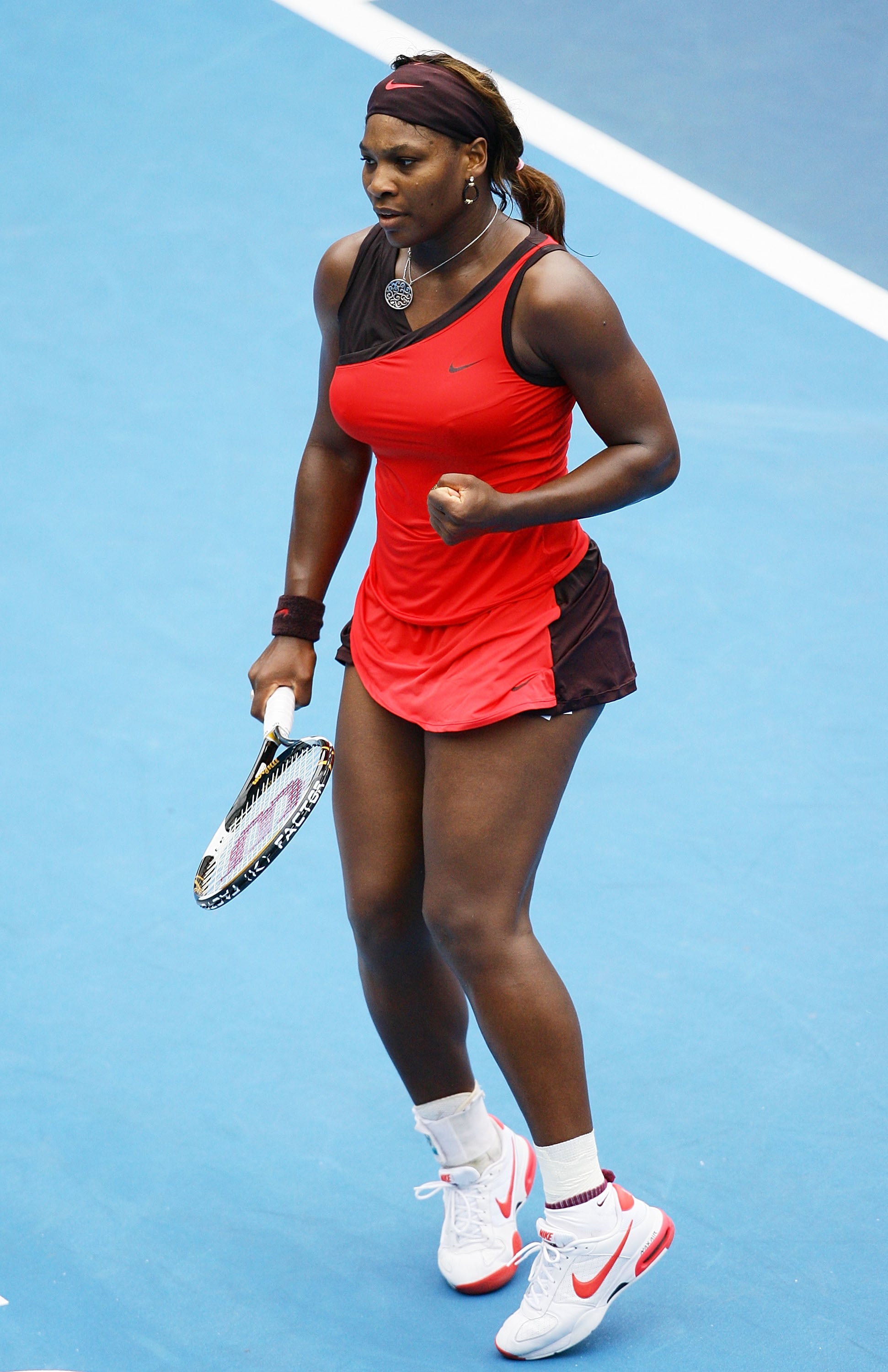 Serena Williams Wearing a Red Swoop Dress at the Medibank International in 2010 | The Coolest Darn Outfits Serena Williams Has Ever Worn on the Tennis Court | POPSUGAR Fashion 11