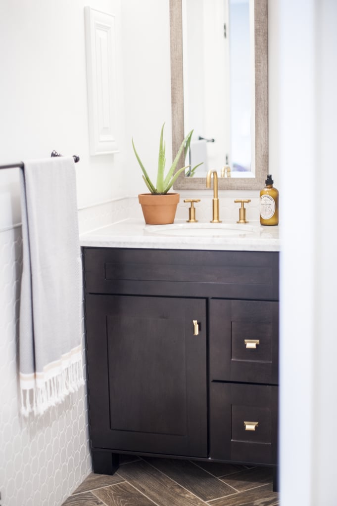 In addition to choosing a sink vanity with real drawers, we snuck in more storage by adding slim wall cabinets in two different places. We decided to paint them the same color as the walls and skip hardware so that you hardly notice them.   
If you're looking for a streamlined process to renovate that doesn't require hiring an expensive interior designer or searching for a contractor on your own, you should definitely consider going the Decorist/Lowe's route. Access to an interior designer for these Decorist/Lowe's renovations will only set you back a flat fee of $299 — a rate that's otherwise hard to find. Renovations are never without hiccups, but having professional design advice and a project manager will help you troubleshoot storage or layout issues, avoid pricey mistakes, and remain organized. If you're thinking of a similar style for your own bathroom, check out my bathroom shopping list to get the look!