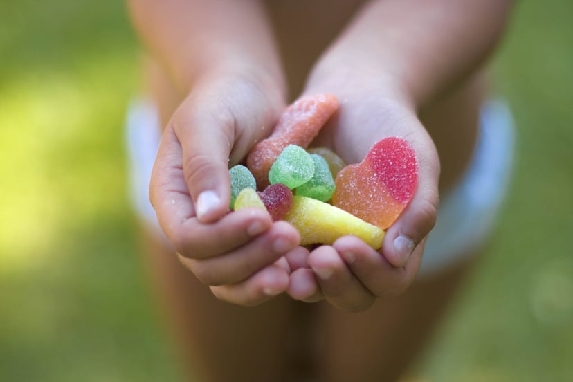 a small girl with candy in her hands.