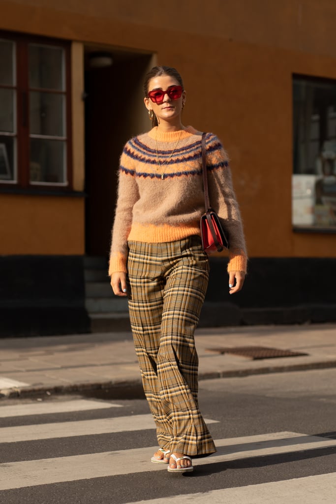 Styling a sweater and plaid pants with a white pair of Havaianas.