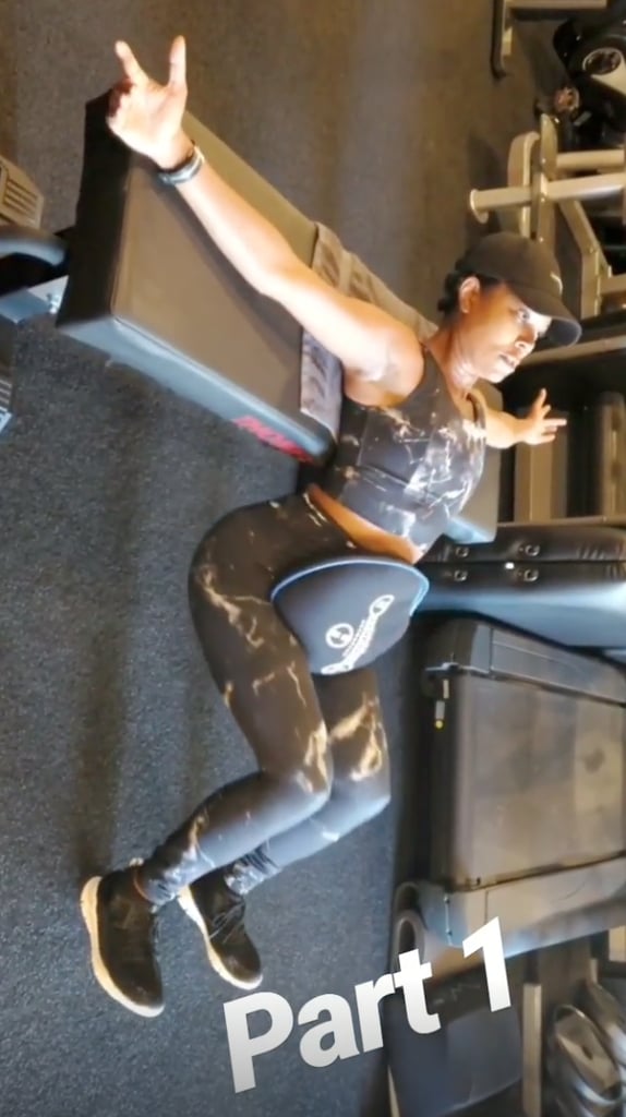Gabrielle worked her glutes by starting with her arms spread across a workout bench and the sandbag situated in her lap. She lowered her booty until it almost hit the floor . . .