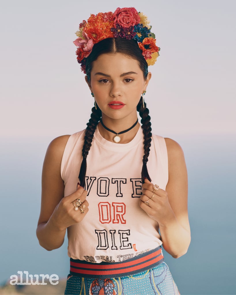 Selena Gomez wearing a Pyer Moss T-shirt, Stella Jean skirt, and Michael Schmidt headpiece and accessorizing with Sarah Hendler earrings and a Isa Noy necklace.