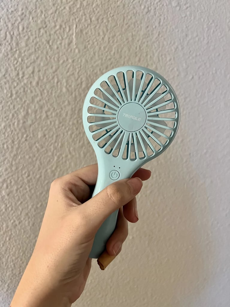 TriPole Mini Handheld Fan ($8, originally $12)
This little fan is kind of genius to keep in your purse, car, or gym bag — you name it. It's perfect for cooling down after a sweaty walk, but it's not just for workouts. Imagine how good it would feel on a stuffy airplane when you're stuck on the runway waiting to take off. Learn more about why you should buy it in our TriPole Mini Handheld Fan review.
Editor Quote: "More than anything else, I love that this rechargeable handheld fan has all the same capabilities of a traditional free-standing fan (think adjustable fan speeds and quick cooling capabilities), all condensed into a portable device that I can easily take on the go. The gadget is remarkably slim and compact, so much so that I can squeeze it into even my smallest crossbody bags. It's also super easy to operate, and with the click of a button, I can turn the device on and seamlessly toggle between different wind speeds." — Kyley Warren, former assistant shopping editor